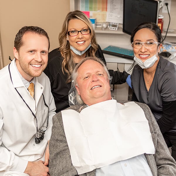 Sumner Dentist-and-his-two-assistants-with-the-patient