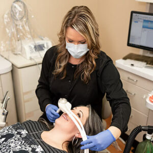 Sedation Dentistry Assistant-checking-the-patient-placing-gas