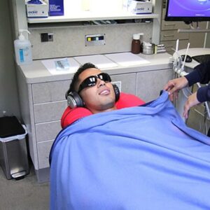 Sedeation Dentistry relaxed-patient-with-headphones-and-blanket