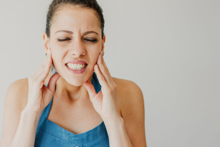 TMJ jaw-pain-lady-holding-her-jaw